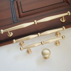 the handles and knobs on this cabinet are gold - colored, but not white