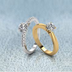 two gold and silver wedding rings with diamonds on the top, one diamond set in the middle