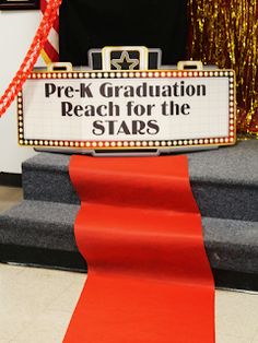 a sign that says pre - k graduation reach for the stars on top of some steps