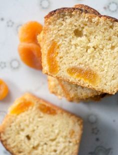 two pieces of cake sitting next to each other on a white plate with oranges