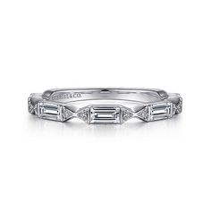 a white gold wedding band with baguettes on the side and diamonds in the middle