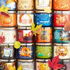 many different types of candles with autumn leaves on them