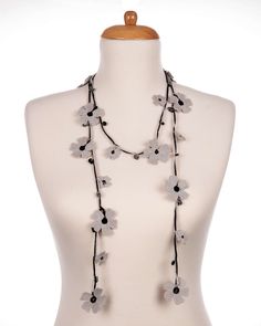 "Elevate your style with our exquisite Black and Gray Crochet Necklace. This stunning neck accessory features a unique butterfly-inspired crochet design, adorned with delicate beads for a touch of elegance. Crafted with fine threads, this necklace showcases the art of micro crochet, setting it apart from other models you may find. Versatile and customizable, our crochet necklace offers endless possibilities to suit your personal style. With three different wrap options, you can create your own signature look by wrapping it around your neck in various captivating ways. Our product photography showcases the necklace on a tailor-sized dummy, providing a visual reference for its impeccable fit and exquisite craftsmanship. Rest assured that the necklace you receive will be carefully handcrafted Bohemian Adjustable Flower Necklace For Parties, Adjustable Flower Necklace For Beach, Adjustable Bohemian Flower Necklace For Party, Adjustable Crochet Jewelry For Parties, Adjustable Crochet Flower Necklace, Ribbon Choker Necklace, Gray Crochet, Micro Crochet, Necklace Crochet