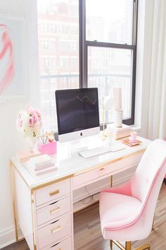 A bright home office with a pink chair and large windows. Pink Accents