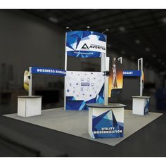 an exhibit stand with blue and white graphics on the front, two displays behind it