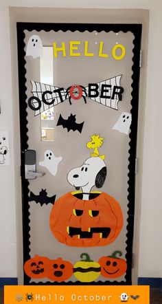 a door decorated to look like a halloween scene with pumpkins, ghost and jack - o'- lantern