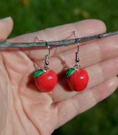 These adorable one-of-a-kind apple earrings are handmade with air-dry clay and paint, and covered in a clear gloss for protection. Perfect to wear when apple picking in the Fall! They are carefully packaged on a card in a cute purple organza bag, so they make a great gift too! Air Dry Clay Jewelry, Air Dry Clay Earrings, Clay Apple, Crazy Earrings, Candy Corn Earrings, Apple Earrings, Clay Dangle Earrings, Polymer Clay Jewelry Diy, Clear Gloss