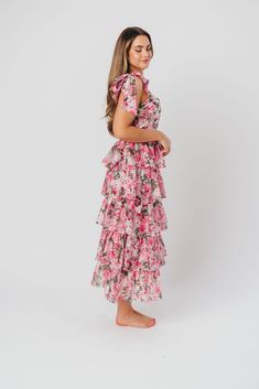 A stunning addition to any fashionista's collection, the Maddie Midi Dress is springtime captured in an organza gown. Crafted from a premium organza in an eye-catching floral pattern, it features a feminine, flouncy silhouette and ruffle details that will have you feeling like a princess on her way to the ball! Style this beauty with strappy sandals and a jeweled clutch and prepare yourself for all the admiring glances. FIT: Runs true to size. Dress will accommodate early pregnancy; note that the bodice is fitted, which could prove restrictive if you are in advanced maternity. MATERIAL: Hand wash cold; do not bleach, do not tumble dry. Line dry, low iron if needed. GARMENT DETAILS: Lightweight, floral-print organza dress in a long midi length. Bustier-style bodice features a square necklin Spring Ruffle Dress With Chiffon Ruffled Skirt, Spring Chiffon Ruffle Dress With Ruffled Skirt, Spring Chiffon Dress With Ruffled Skirt, Floral Chiffon Midi Dress With Ruffles, Chiffon Floral Midi Dress With Ruffles, Chiffon Midi Floral Dress With Ruffles, Floral Midi Dress With Ruffles For Party, Spring Party Rose Print Maxi Dress, Party Floral Midi Dress With Ruffles