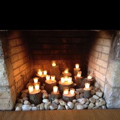 many lit candles are placed in the fireplace