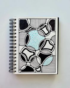 a notebook with black and white designs on it