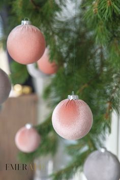 pink and silver ornaments hanging from a christmas tree