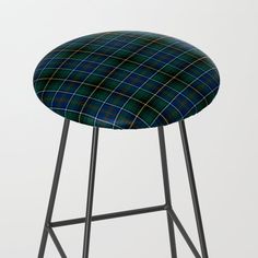 a green and blue plaid stool with black metal legs on an isolated white background,