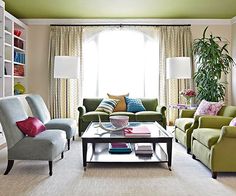 a living room with couches, chairs and a coffee table in front of a window