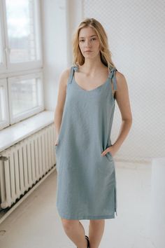 Linen slip dress with ties, pockets and side slits. Length can be adjusted with ties.Handmade from washed and softened medium weight 100% linen.DESCRIPTION:-High quality European linen (OEKO-TEX certified);-Colors on model: carmine red, cornflower blue, white, turquoise, rust, graphite (other colors please choose on the right);-Medium weight linen;-Not transparent;-Softened;-Doesn't shrink anymore;-No need to iron.SIZES:For perfect fit please send us your bust and hip measurements when ordering! Linen Slip Dress, Blue Linen Dress, Summer Shift Dress, Sleeveless Summer Dress, Short Sleeve Shirt Women, Sleeveless Dress Summer, Dress With Tie, Fashion Design Clothes, Linen Dress