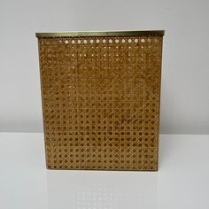 a brown basket sitting on top of a white table