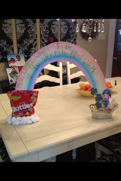 a white table topped with a rainbow arch