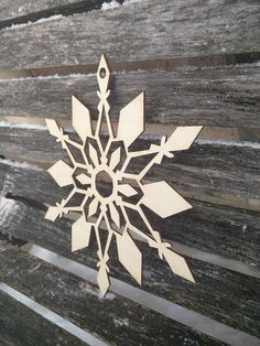 a wooden snowflake sitting on top of a wooden bench