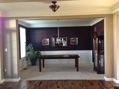 a living room with purple walls and wooden floors