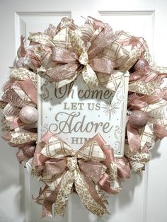 a welcome sign hanging on the front door with pink and white ribbons attached to it