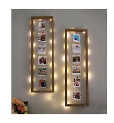 two framed pictures with lights hanging on the wall