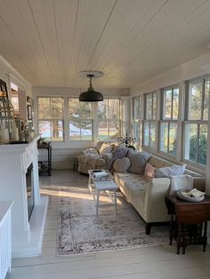 a living room filled with furniture and lots of windows