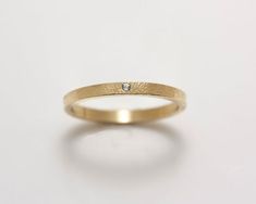 A sparkling 1.5 mm white sapphire flush set in a 14k gold 2 mm band in this striking minimalist ring. The band has been embellished with delicate pinpoint hammering. A flush setting gives an added amount of security to the stone. The ring can be worn by itself or as an accompaniment to another ring.  This ring would make a beautiful engagement or wedding ring. Or a "just because" ring!Please allow up to 3 weeks processing time for filling your order.Please contact me for information if you are n Flush Setting, Flush Set Diamond, Band Ideas, Engagement Rings Affordable, London Blue Topaz Ring, Clover Earrings, Gold Band Ring, Minimalist Ring, Ring Fit