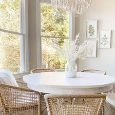 a white table with four chairs around it