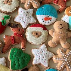 many decorated cookies are displayed on a table