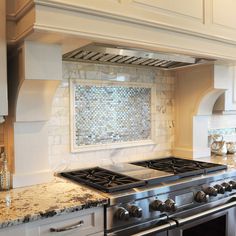 a stove top oven sitting inside of a kitchen next to an oven hood and counter