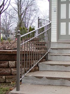 a fire hydrant sitting on the side of a set of steps next to a house