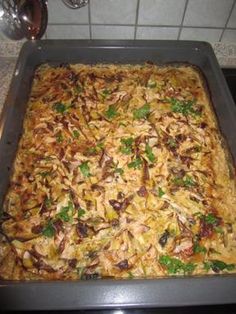 a pan filled with food sitting on top of a stove