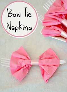 bow tie napkins sitting on top of a table next to a fork and spoon