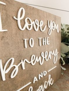 a wooden sign that says i love you to the brewery and back in white lettering