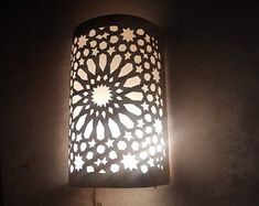 a lamp that is lit up in the dark with light coming from it's side