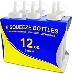 six squeezeze bottles in a blue box with yellow border and white caps on each side