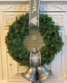 a christmas wreath with bells hanging from it