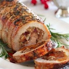 meatloaf wrapped in herbs on a white plate