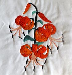 an embroidered piece of cloth with flowers on it