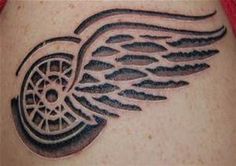 a close up of a tattoo on the back of a woman's shoulder with wings