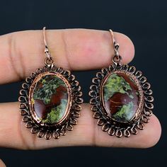 Note : Due to the natural formation of this gemstone. Slight variation in design and color are to be expected. Dragon Bloodstone Earring Electroformed Copper Earring Gemstone Earrings Copper Jewelry Handmade Earrings Gift For Mom Electroformed Jewelry Handmade Electroformed Copper Earrings  SKU : HZE-82 Gemstone : Dragon Bloodstone Stone Shape : Oval Metal Purity : Copper Earring Length : 53 MM Earring Width : 30 MM Artisan Oval Earrings With Natural Stones, Artisan Copper Earrings With Natural Stones, Nature-inspired Earrings With Natural Stones, Nature-inspired Earrings With Natural Stones For Gift, Nature-inspired Natural Stone Earrings For Gift, Copper Natural Stone Drop Earrings, Nature-inspired Dangle Gemstone Earrings, Nature-inspired Gemstone Dangle Earrings, Dragon Bloodstone