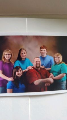 a family portrait hanging on the wall