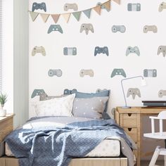 a child's bedroom decorated in blue and white with video game controllers on the wall