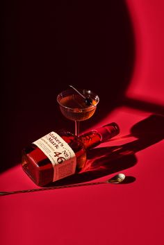 a bottle of liquor sitting on top of a red table