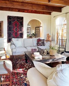 a living room filled with furniture and rugs