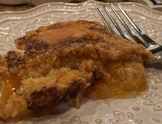 a piece of pie sitting on top of a white plate with a fork next to it