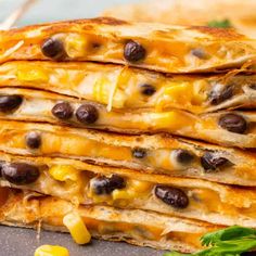 several quesadillas stacked on top of each other with olives and cheese