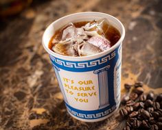 a cup filled with ice and coffee beans