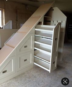 an unfinished kitchen under construction with cabinets and drawers in the bottom half, below which is a pull out pantry