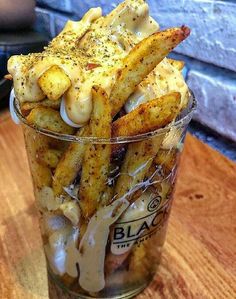 french fries in a glass on a wooden table