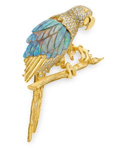 This inventive brooch by famed goldsmith and designer Henry Dunay takes the unique shape of a tropical Macaw bird. The playful design features a rare fossilized opal that totals an impressive 21.69 carats. Carved to appear like the bird's feathers, the bird's body is forged in 18K yellow gold and encrusted in sparkling white diamonds totaling 2.01 carats. Whimsical yet refined, this brooch showcases the creative aesthetic of Henry Dunay jewels. 2 3/4" length Macaw Bird, Jean Schlumberger, Brooch Design, Charleston Art, Animal Themed Jewelry, Creative Aesthetic, Figural Jewelry, Peruvian Blue Opal, Fancy Jewelry Necklace